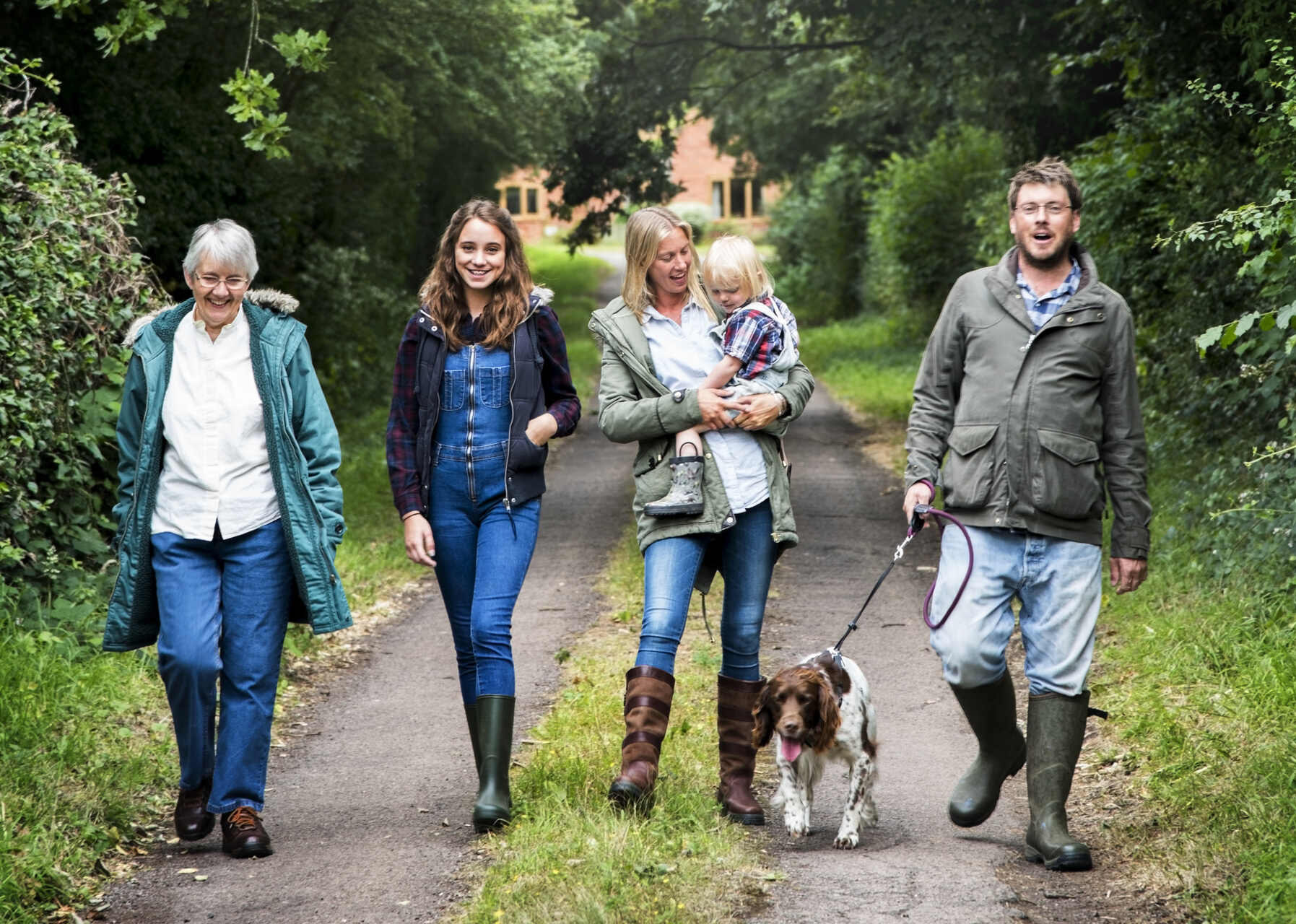 A family walking a dog outdoors