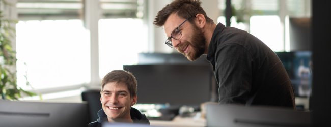 A pair of Tractive employees working together on a project